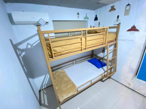 a bedroom with bunk beds in a room at Neo Robiu & Ijen Tour in Banyuwangi