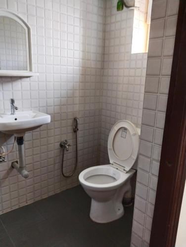a bathroom with a toilet and a sink at JK BNB Stay in Vagator