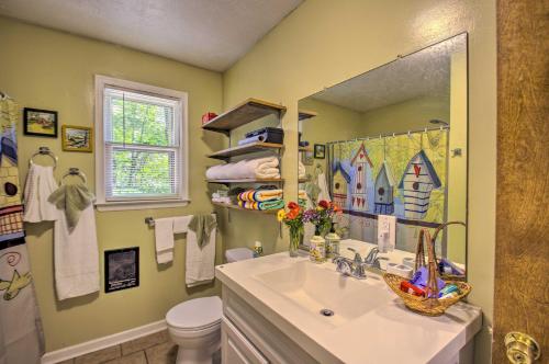 a bathroom with a sink and a mirror and a toilet at Quaint Hinton Hideaway - Hunt and Fish Nearby! 