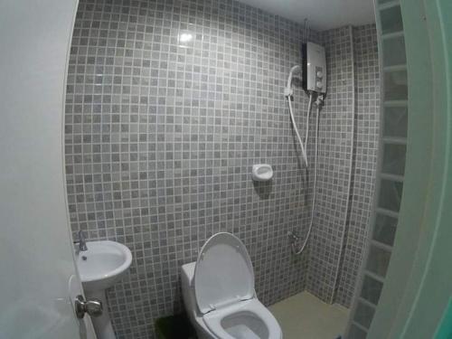 uma casa de banho com um chuveiro, um WC e um lavatório. em Cebu Leisure Lodge em Cebu