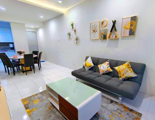 a living room with a couch and a table at Decozy 6 Ipoh Town Condo 8-10pax in Ipoh