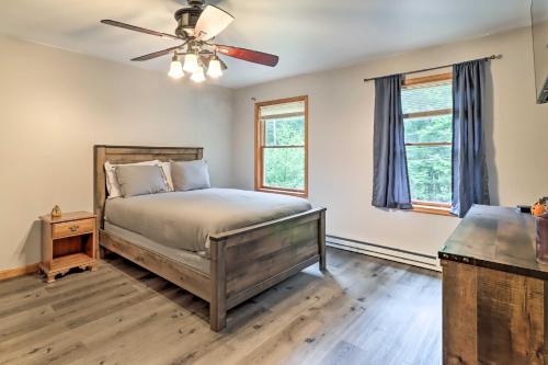 a bedroom with a bed and a ceiling fan at Pocono Gem with Deck and Fire Pit, 9 Mi to Skiing! in Bushkill