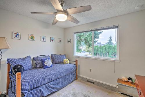 a living room with a blue couch and a window at Spacious Kent Getaway with Yard, Deck and Grill! in Kent