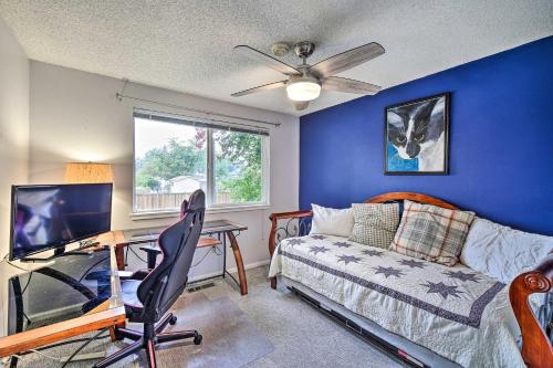 a living room with a couch and a desk with a television at Spacious Kent Getaway with Yard, Deck and Grill! in Kent