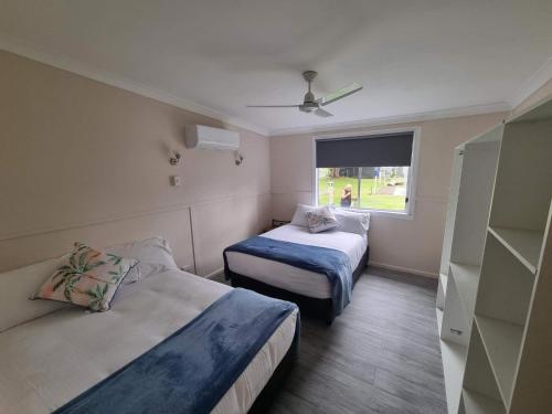 a hotel room with two beds and a window at Glenwood Tourist Park & Motel in Grafton