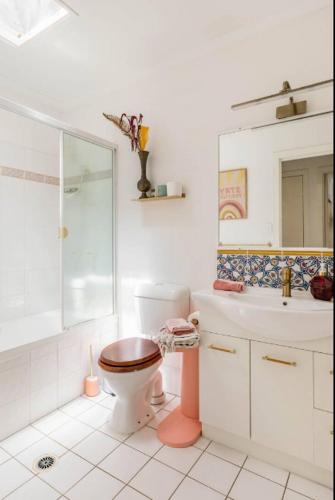 a bathroom with a toilet and a shower and a sink at Midnights in Morocco in Brisbane