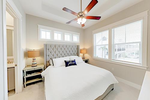 a bedroom with a white bed and a ceiling fan at Prominence Moby Dick in Inlet Beach