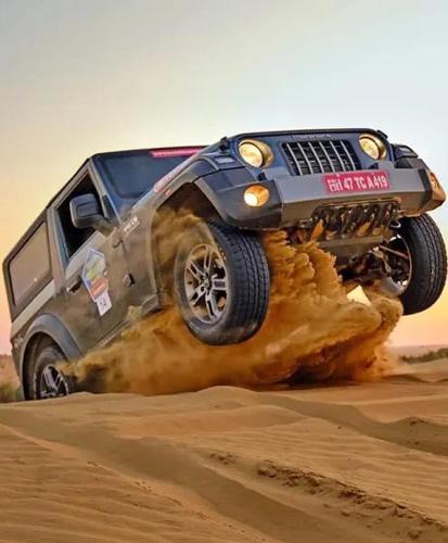 a jeep jumping in the sand in the desert at Marina Dessert Camp in Sām