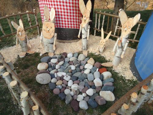 a group of rabbits standing around a pile of rocks at Apartments Akacijev Izvir in Miklavž na Dravskem Polju