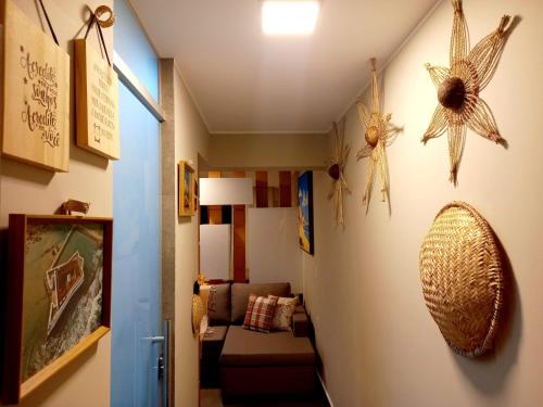 a hallway with a living room with a couch at Ilusion Flats Aconchego de Ponta Negra in Natal