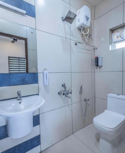 a bathroom with a toilet and a sink at Dune Homestay in Alleppey