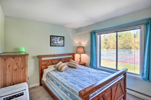 a bedroom with a bed and a large window at Comfortable Dover Apartment Walk to Mt Snow! in Dover