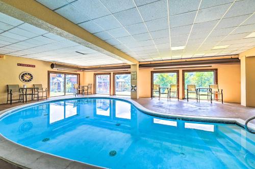 a large swimming pool in a large room with windows at Comfortable Dover Apartment Walk to Mt Snow! in Dover