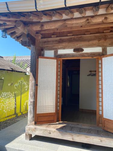 an entrance to a house with a wooden door at Gyodong Gaon in Jeonju