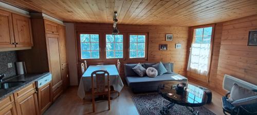 a living room with a couch and a table at 2 bedroom chalet with a mountain view in Saint-Jean