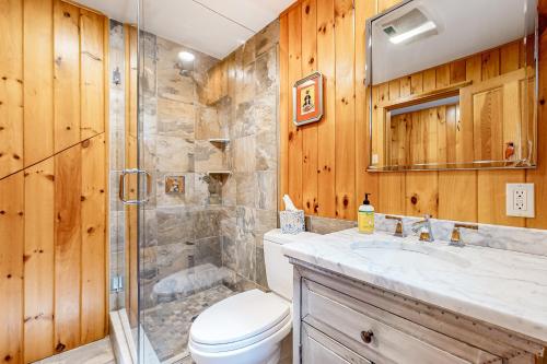 a bathroom with a shower and a toilet and a sink at Marwood Lake Cottage in Wakefield