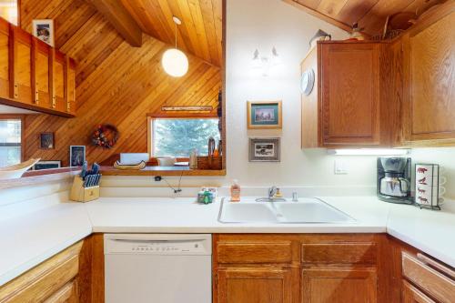 a kitchen with wooden cabinets and a sink at Snowcreek 56 in Mammoth Lakes