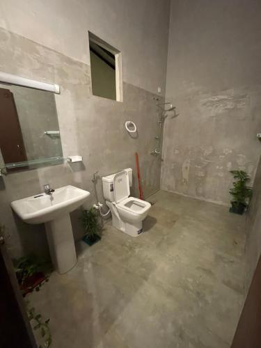 a bathroom with a toilet and a sink at Sea Sands Beach Hostel in Negombo