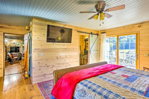 a bedroom with a bed and a ceiling fan at Lovely Flat Rock Cabin from 1905 with Fireplace in Rising Fawn