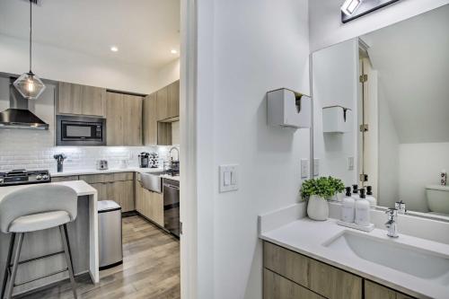 a white kitchen with a sink and a counter at Newly-Built Luxury Galleria Area Townhome! in Houston