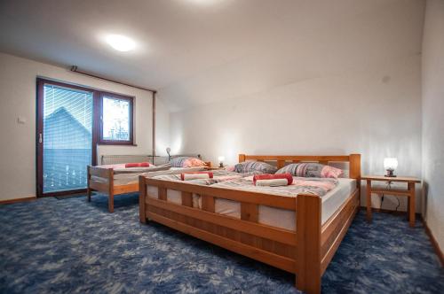 1 dormitorio con 2 camas y ventana grande en Apartments Jože Pekovec, en Bohinj