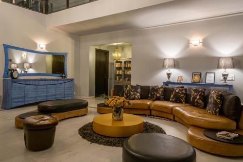 a large living room with a couch and a table at StayVista at The Banyan Abode with Pool Table, Pet Friendly & Outdoor Pool in Manesar