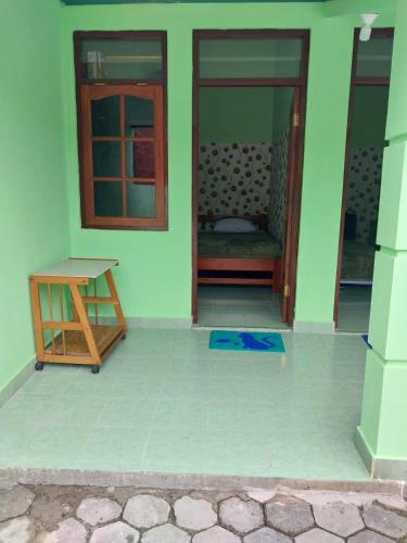 a room with a door and a table on the floor at Omah 365 Homestay in Sentool