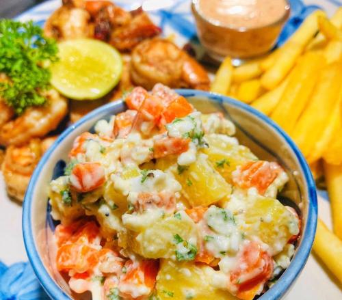 a bowl of food with vegetables and other foods at Richards Cabanas in Tissamaharama