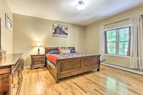 een slaapkamer met een bed en een raam bij Grand Pine Bush Retreat on 2 Acres with Deck! in Pine Bush