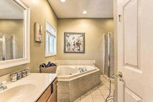 een badkamer met een bad en een wastafel bij Grand Pine Bush Retreat on 2 Acres with Deck! in Pine Bush