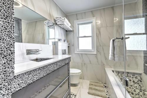 a bathroom with a shower and a sink and a toilet at New Haven Gem with Private Pool, Walk to Beach! in New Haven