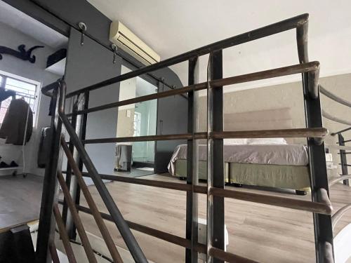 a wooden bunk bed in a room with a window at Loft Apartment Cape Town The Waterkant in Cape Town