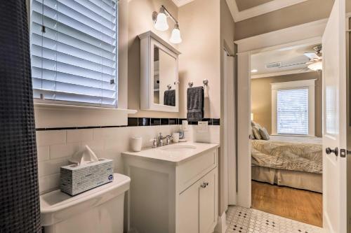 a white bathroom with a sink and a bedroom at Hyde Park Luxury Studio with Prime Location! in Tampa