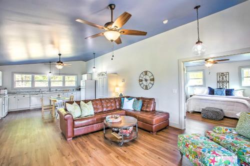 a living room with a couch and a bed at Granvilles Blue Cottage Porch and River View! in Granville