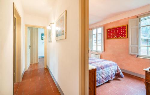 a bedroom with a bed and a window at Nice Home In Camaiore With 3 Bedrooms And Wifi in Camaiore