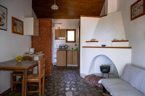 a living room with a table and a kitchen at House with with a spectacular sea view in Koumeika