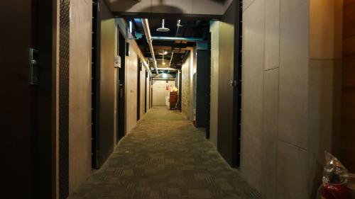 a long corridor in an office building with a long hallway at NYS Loft Hotel in Taipei