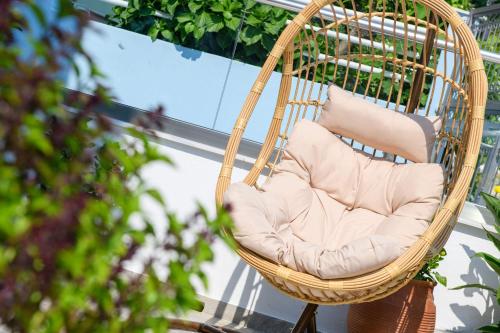 a wicker rocking chair sitting on a balcony at Ninemia Studios in Limenas