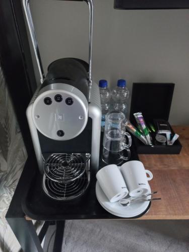 a table with a coffee maker on top at Boutique Hotel De Oude Veste in Hellevoetsluis