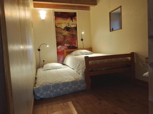 a small bedroom with two beds and a table at Le Chalet du Parc in Annonay