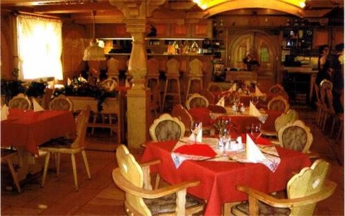 a restaurant with tables and chairs with red table cloth at Land-gut-Hotel Zur Lochmühle in Penig