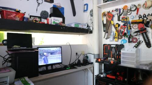 a room with a desk with a computer and tools at BALI AMED FEEL HOME VILLA in Amed