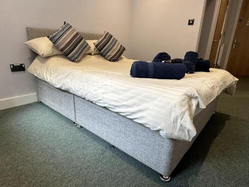 a large bed with pillows on it in a room at No 5 Ocean Cabins - Saundersfoot Harbour - Saundersfoot in Saundersfoot