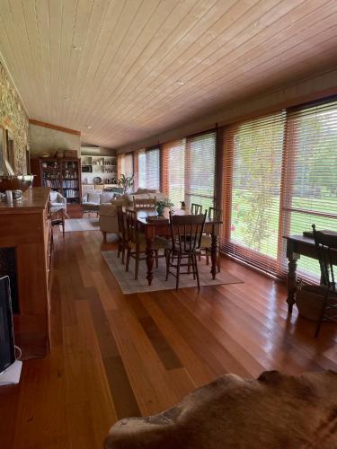 a large living room with a table and chairs at The Coach House on River and Park in Mudgee