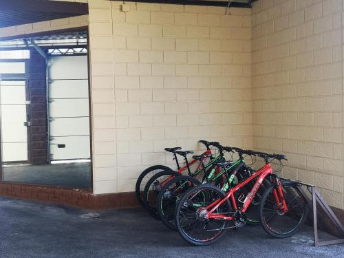 a row of bikes parked next to a wall at Гостевой дом Discovery in Almaty