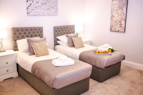 a bedroom with two twin beds with towels on them at Redmayne House in Lake District National Park