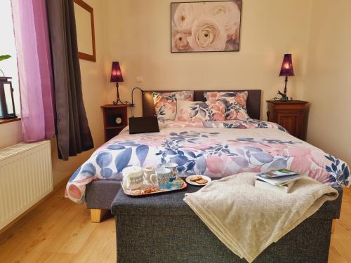 a bedroom with a bed with a laptop on it at Chambres d'hôtes "Le Clos de la Baie" in Paimpol