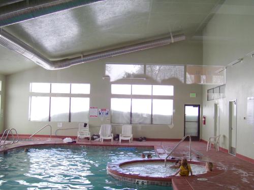 a pool in a room with a person in the water at Powder Ridge Village, a VRI resort in Powder Mountain West