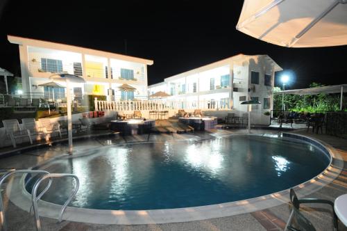 a large swimming pool in front of a building at night at Villeta Boutique Hotel Spa in Villeta
