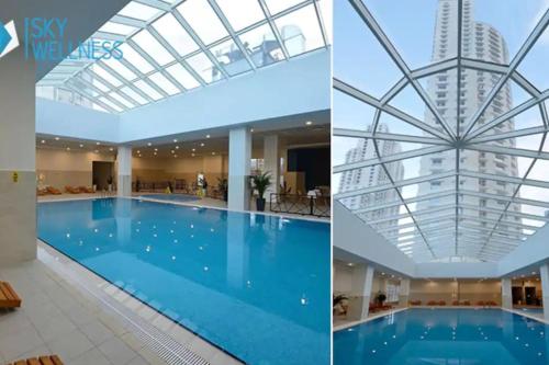 a hotel swimming pool and a building with a glass ceiling at 2BR Lux Apartment in Skopje-Free Parking in Skopje